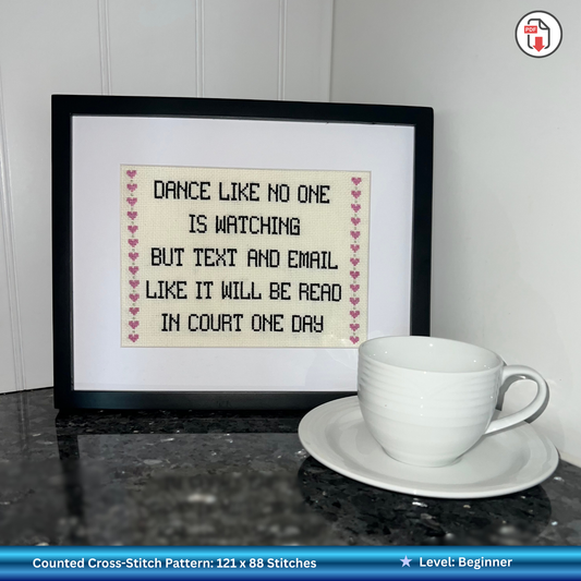 Funny law-related cross stitch pattern in a black frame with a white cup in front