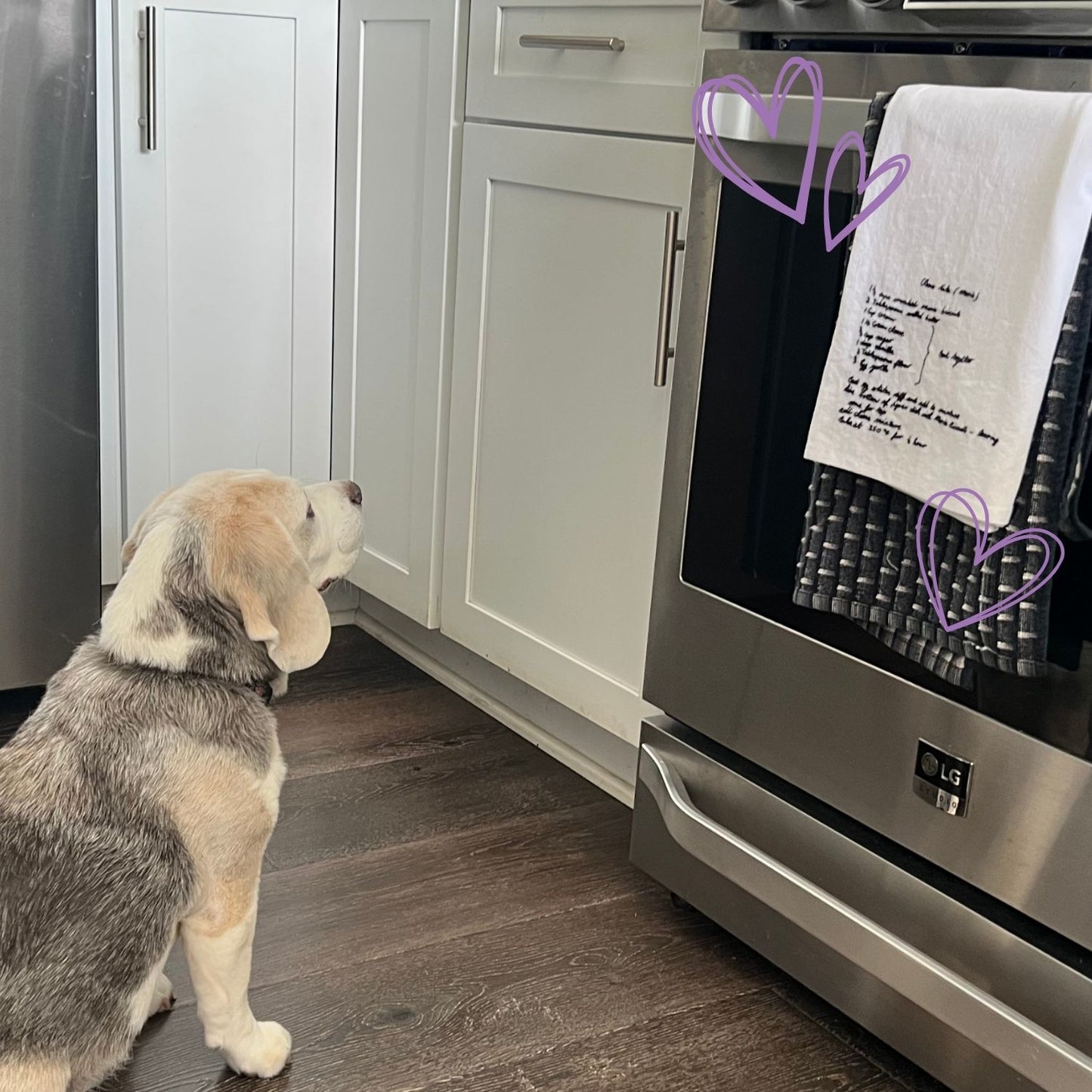 Dog looking at a hand embroidered dish towel with family recipe
