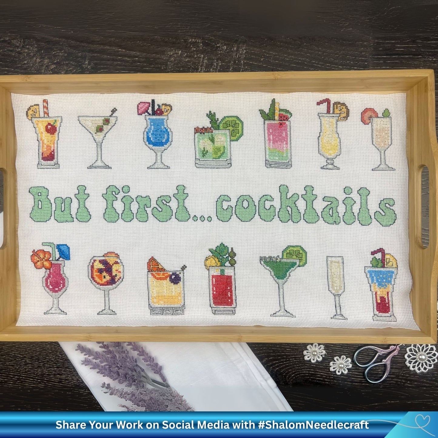 Wooden tray with a cross stitch pattern featuring cocktail glasses and text 'But first... cocktails'.