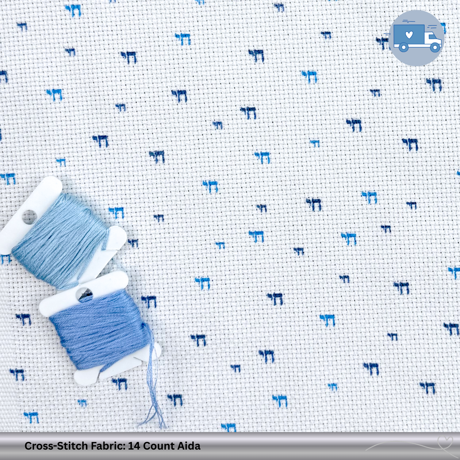 Cross-stitch fabric with blue Chai patterns and two spools of thread on a white background.