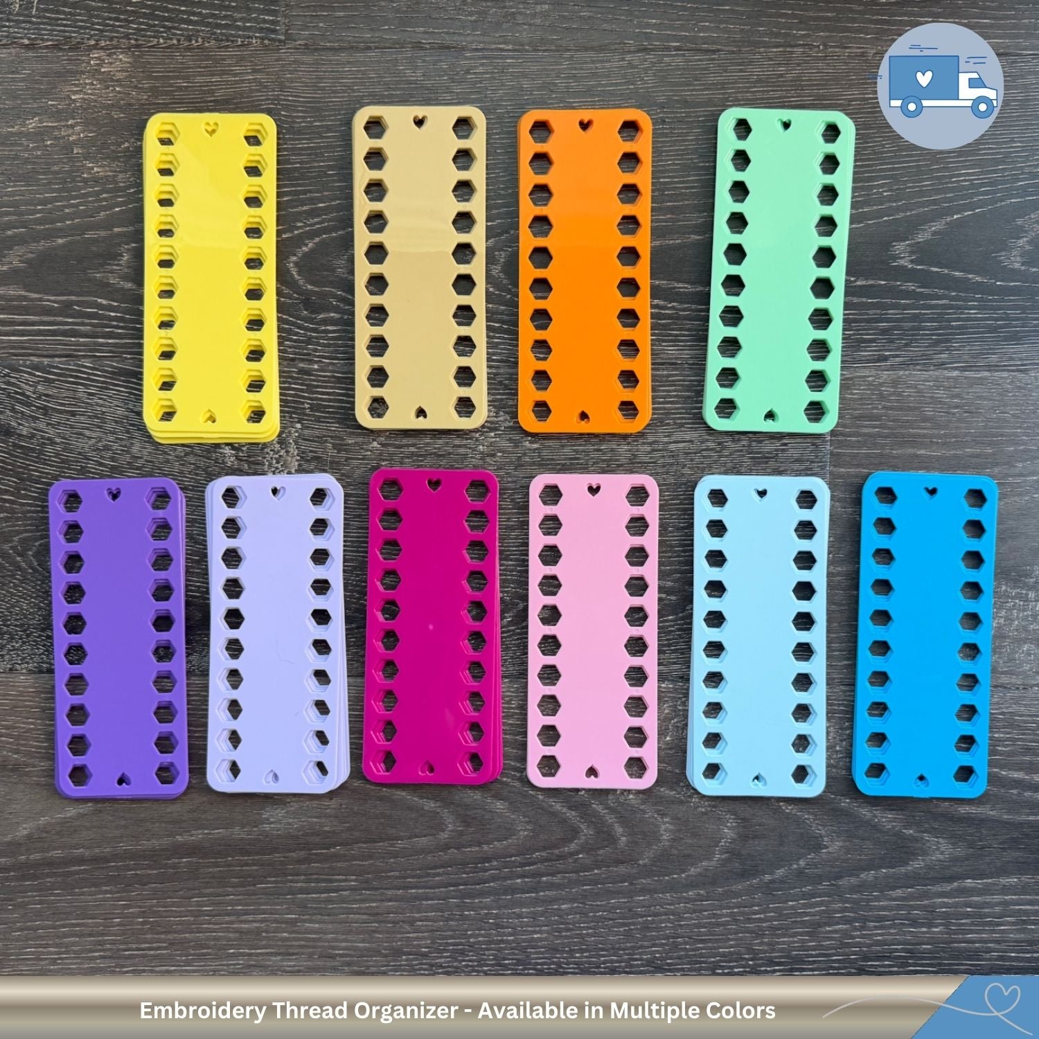 Set of embroidery thread organizers in various colors on a wooden surface.