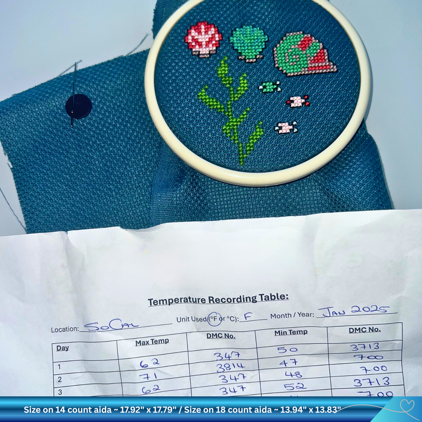 Embroidery hoop with sea life design on blue fabric, temperature recording sheet below