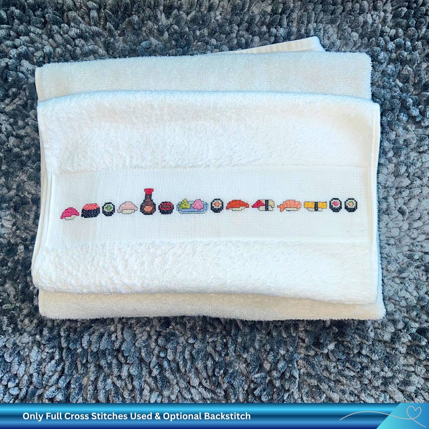 Folded towel with cross-stitched sushi design on a textured surface