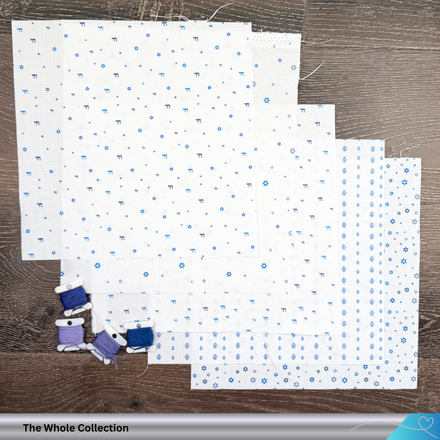 Collection of white Aida fabric with meaningful Judaica symbols on a wooden surface