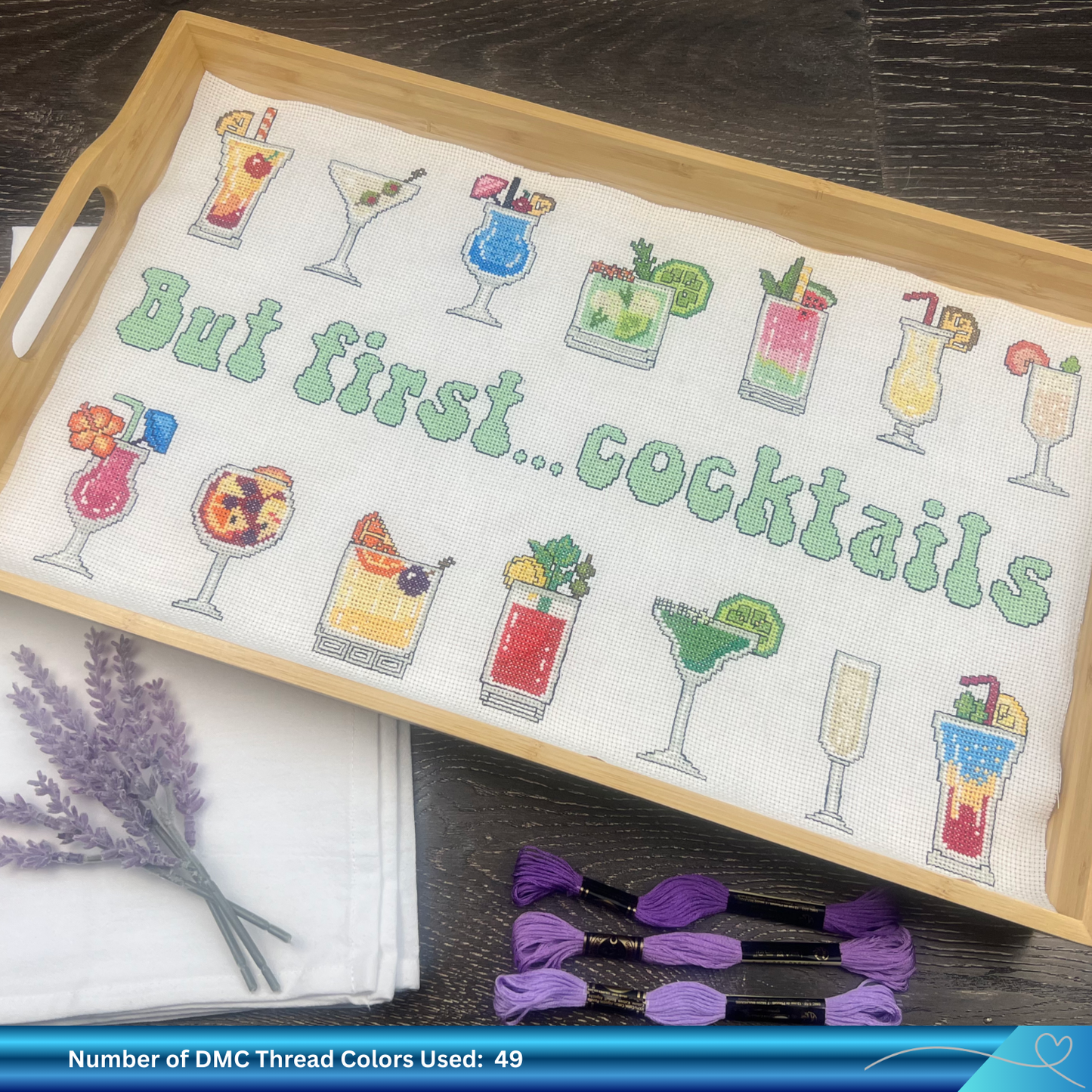 Cross-stitched tray with cocktail designs and text 'But first... cocktails' on a wooden tray.