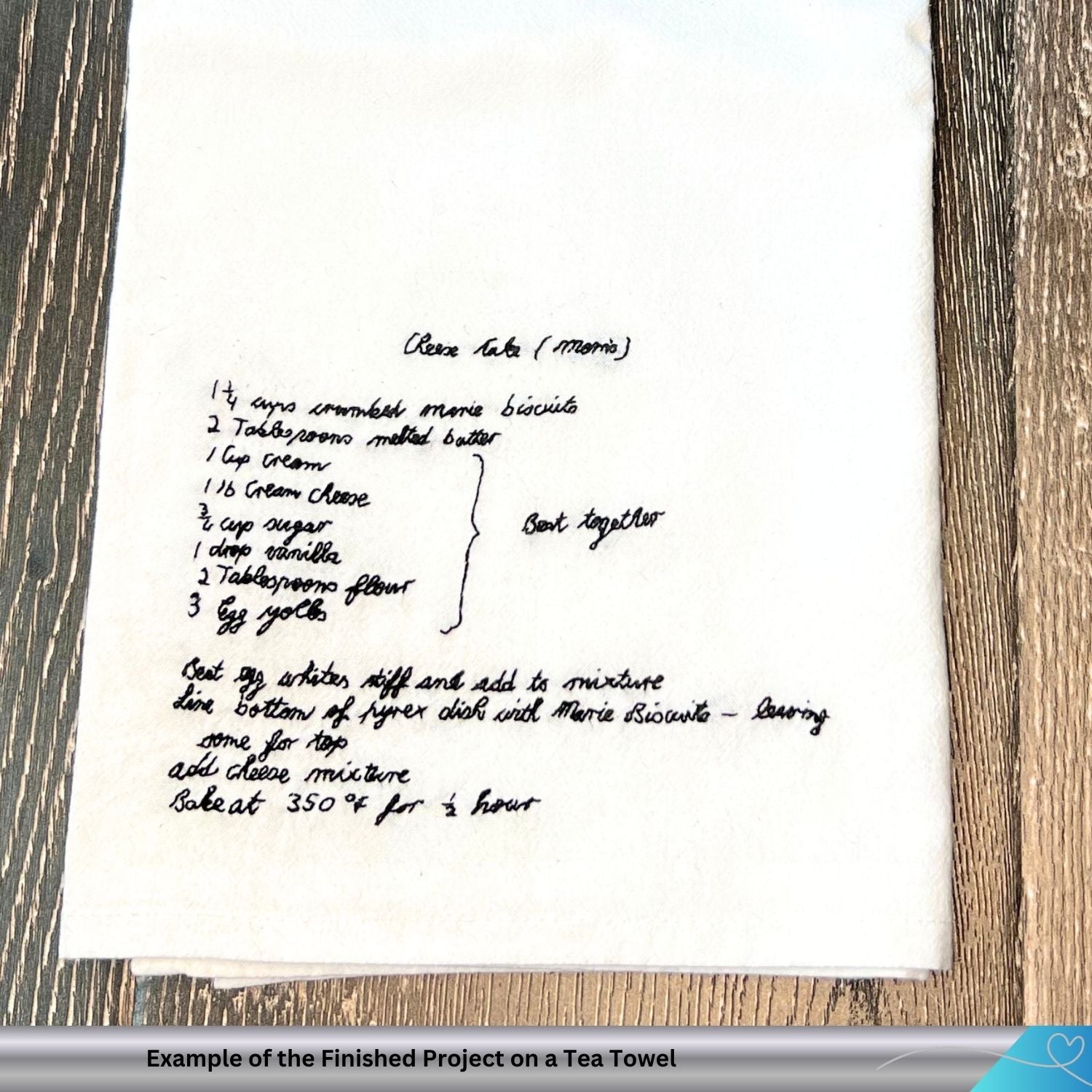 Hand stitched family recipe on a white cotton towel against a wooden background