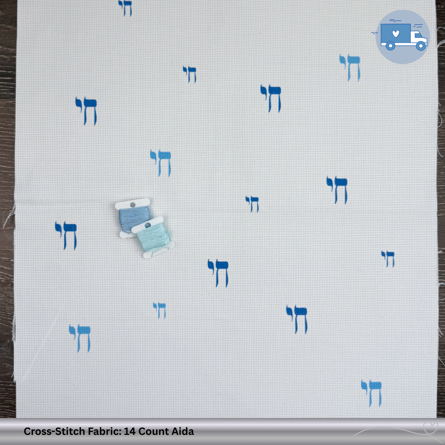 Cross-stitch fabric with blue Chai symbols on a wooden background