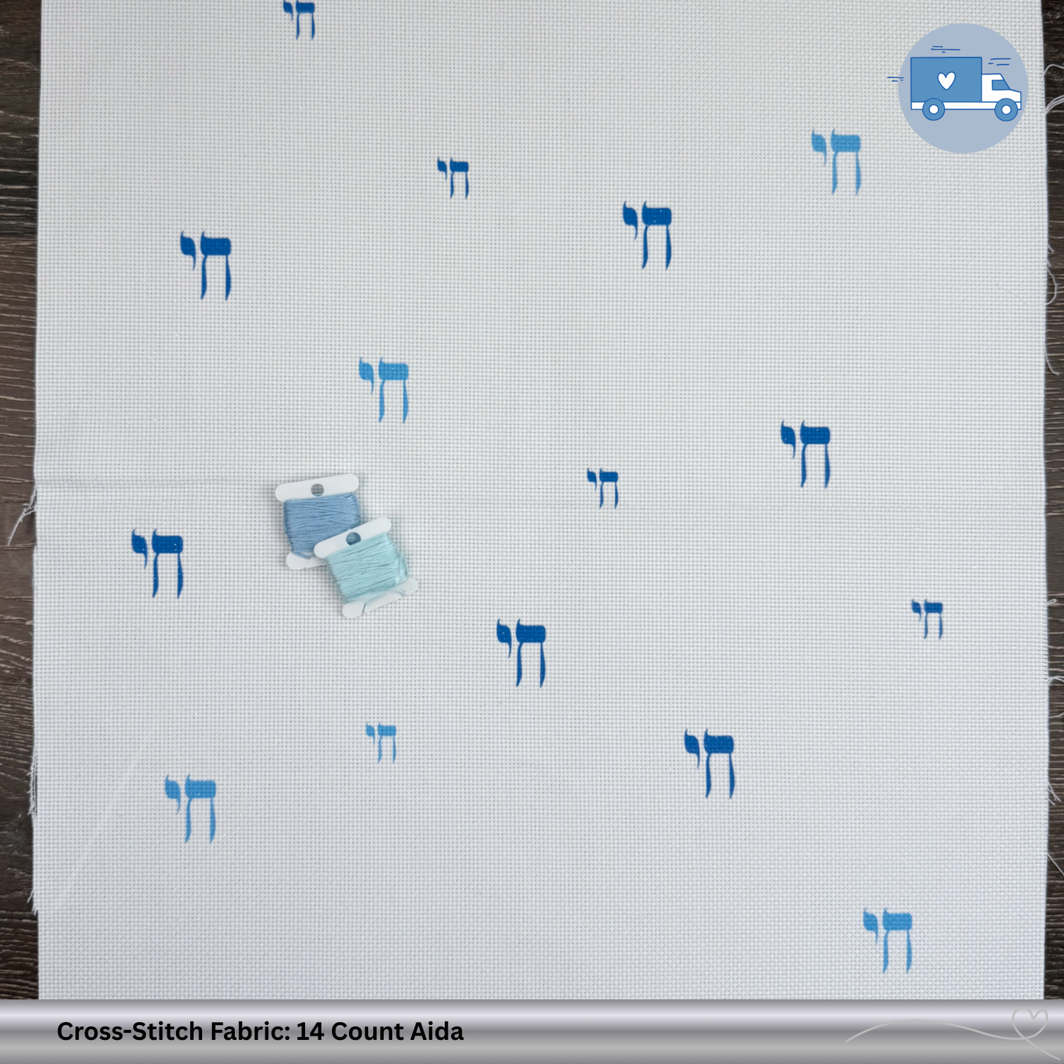 Cross-stitch fabric with blue Chai symbols on a wooden background