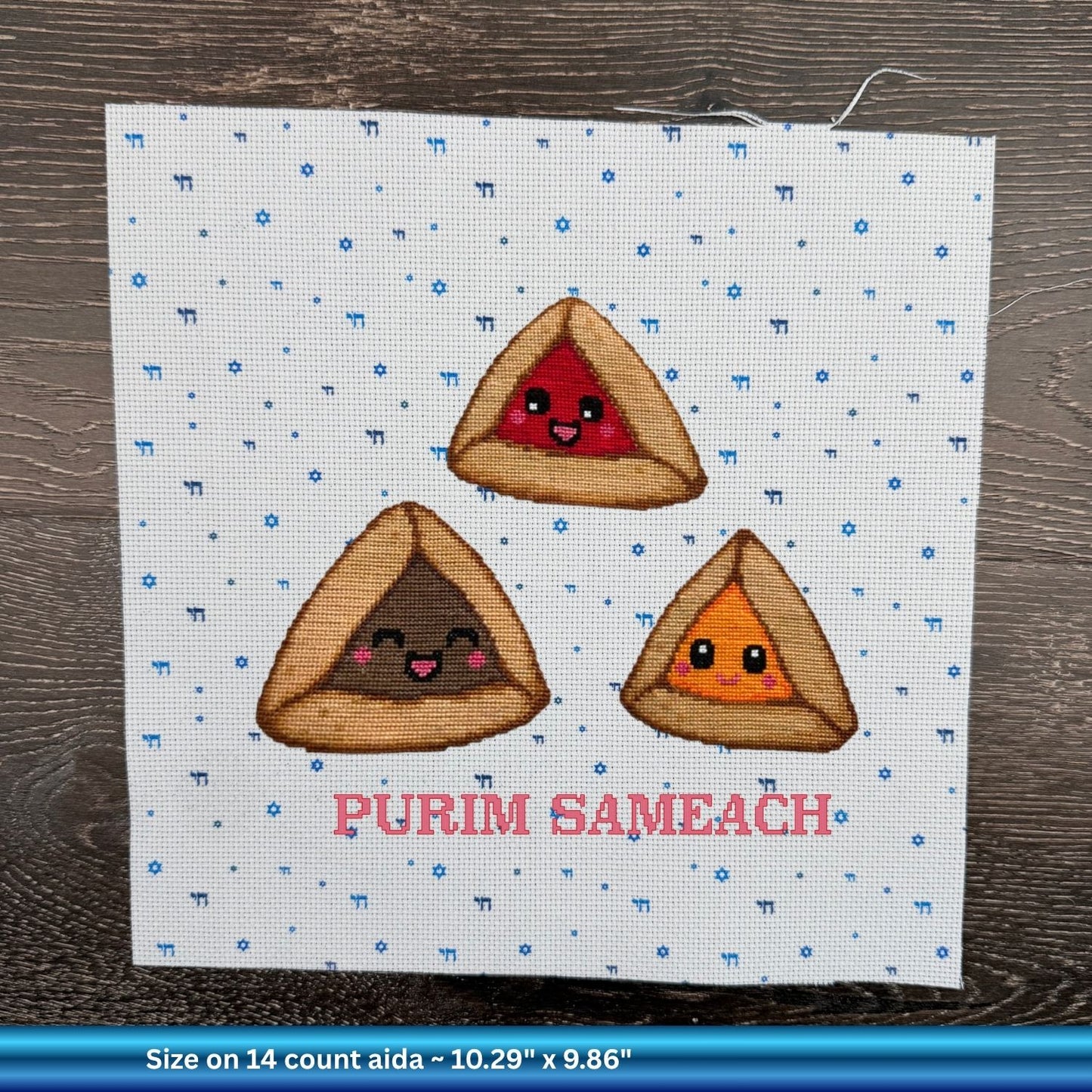 Cross-stitched design of hamantaschen with smiling faces and 'PURIM SAMEACH' stitched on Jewish Aida