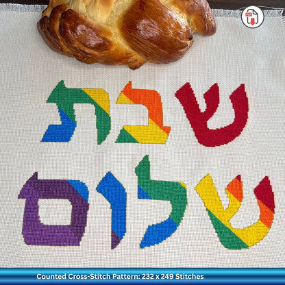 Colorful Hebrew text on a white Aida cross stitch fabric background