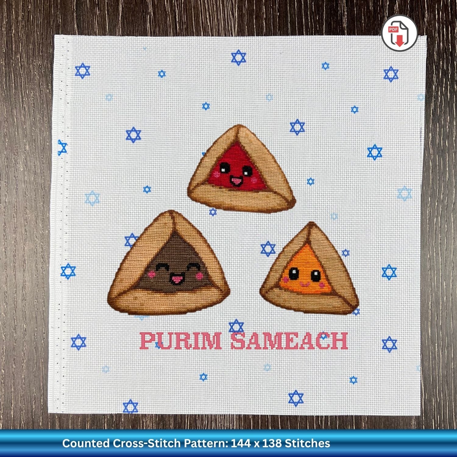 A counted cross-stitch pattern design featuring three cute, smiling Purim Sameach (hammers) on a white fabric background with blue Star of David accents and the text 'PURIM SAMEACH'.