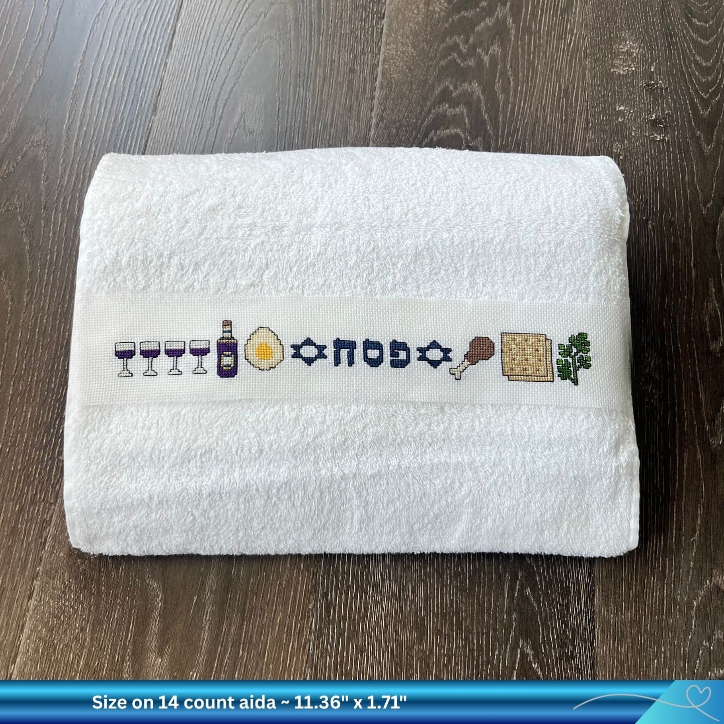 Finished cross-stitched Passover design on a folded hand towel 