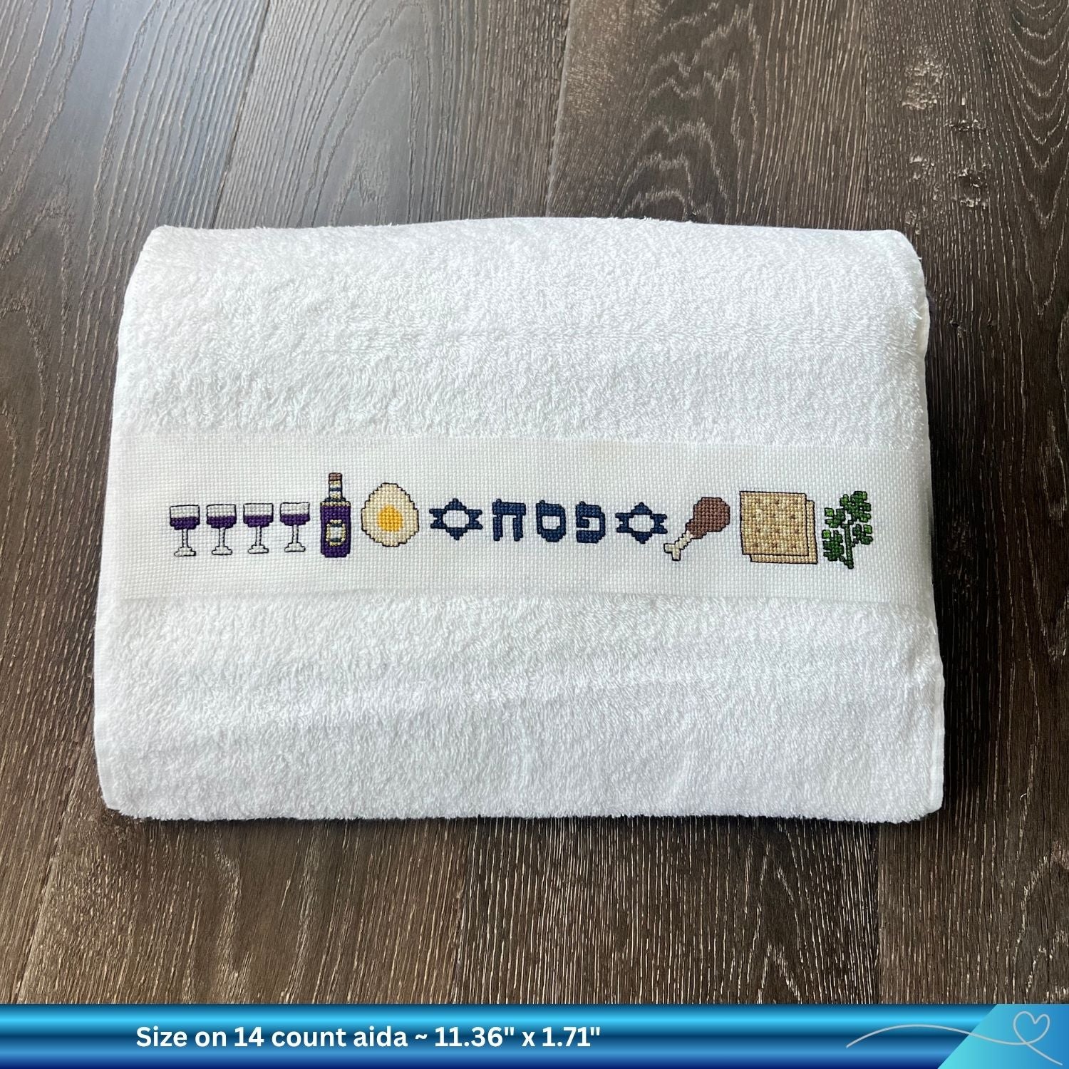 Finished cross-stitched Passover design on a folded hand towel 