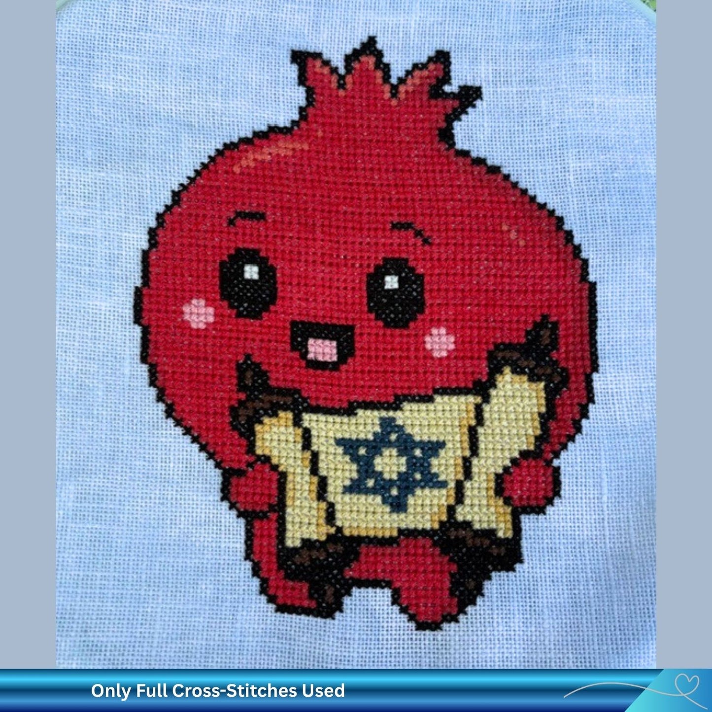 Cross-stitched design of a Jewish pomegranate character holding a Torah  scroll on blue linen embroidery fabric. The text below reads "only full cross stitches used"