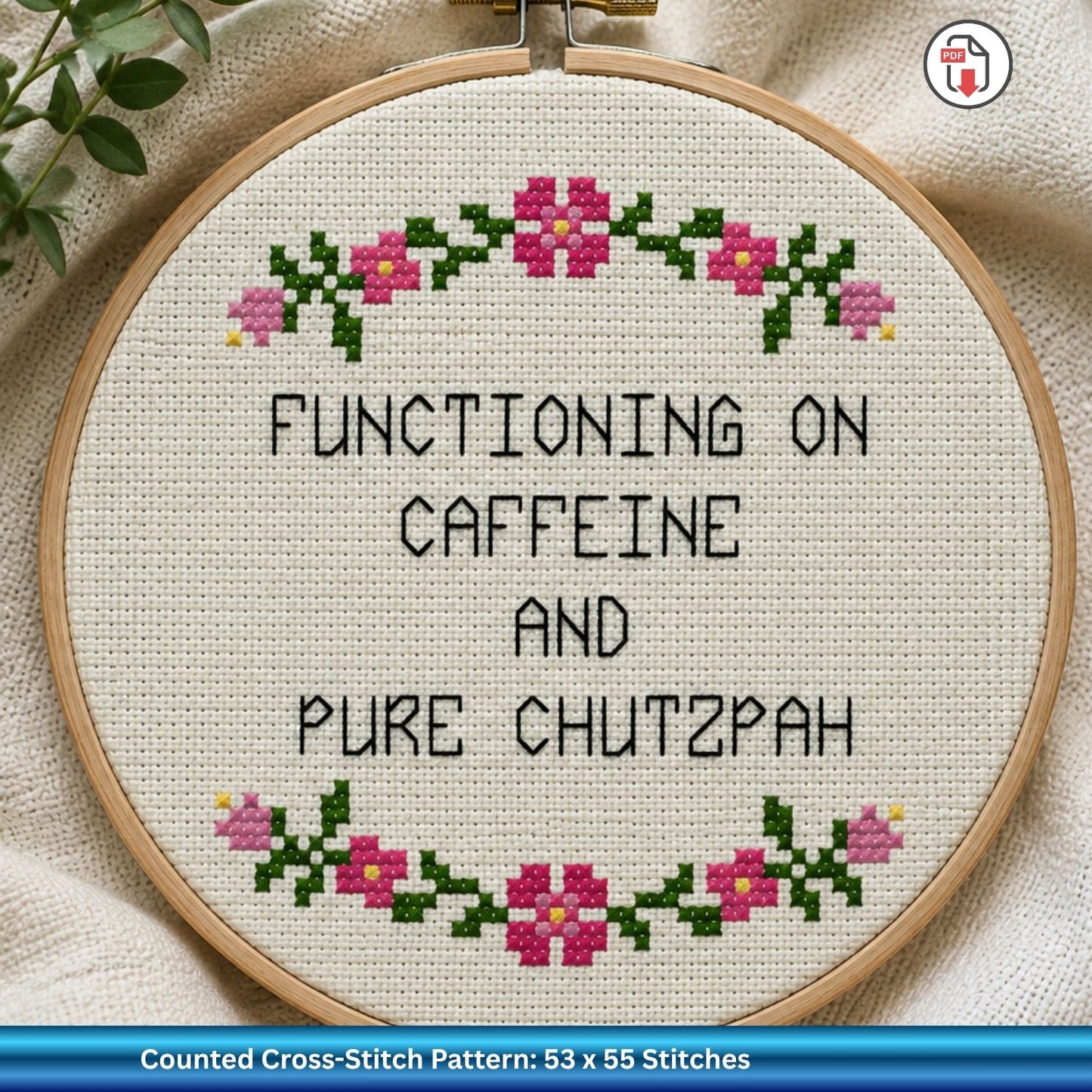 Cross-stitched hoop with text 'Functioning on caffeine and pure chutzpah' on a fabric background