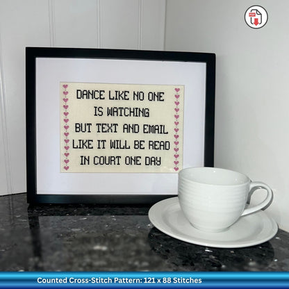 Funny law-related cross stitch pattern in a black frame with a white cup in front
